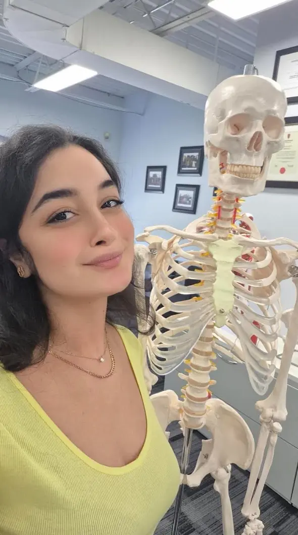 Salma Zakari with an anatomical skeleton model